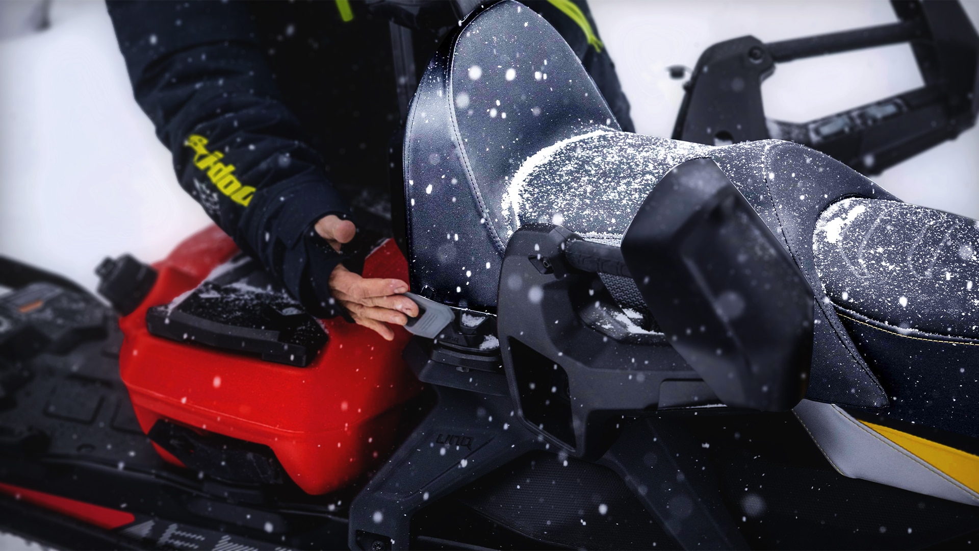 Person adding a passager seat to a Ski-Doo snowmobile