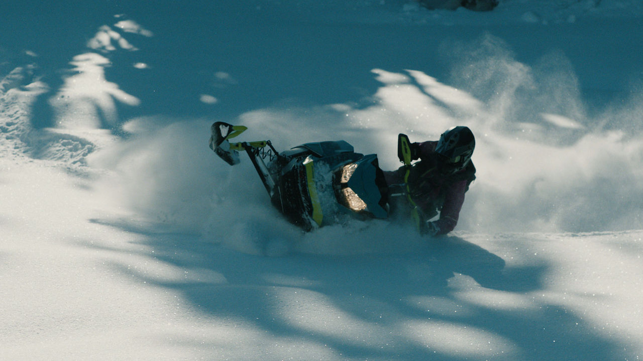 Sara Dufour riding a Ski-Doo in deep powder