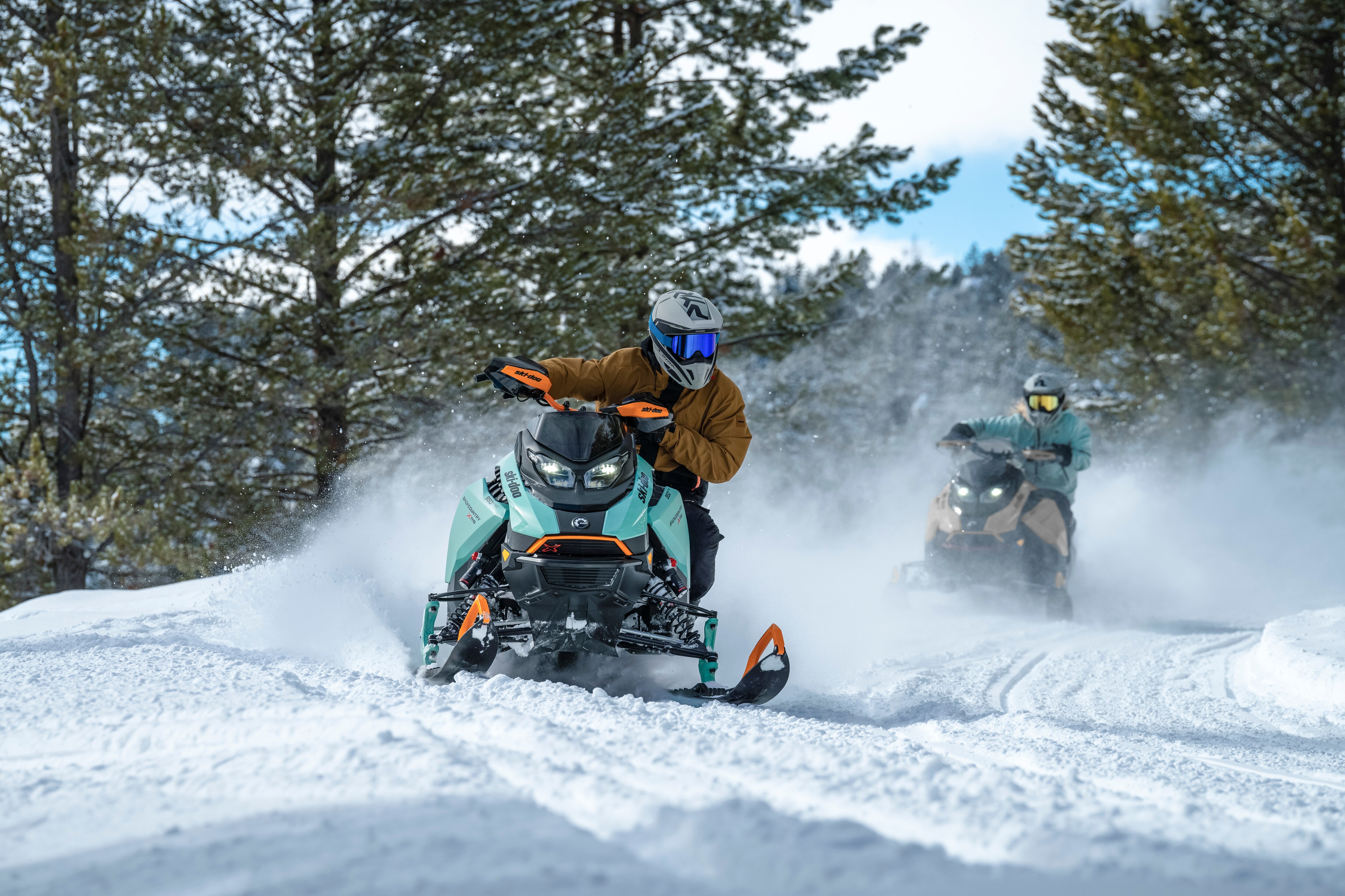 Two snowmobilers riding Ski-Doo Backcountry in trail