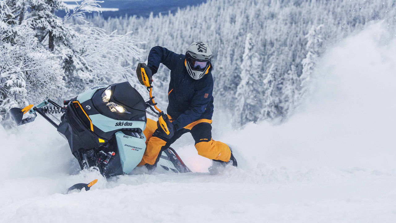Man riding a Backcountry X-RS in deep snow