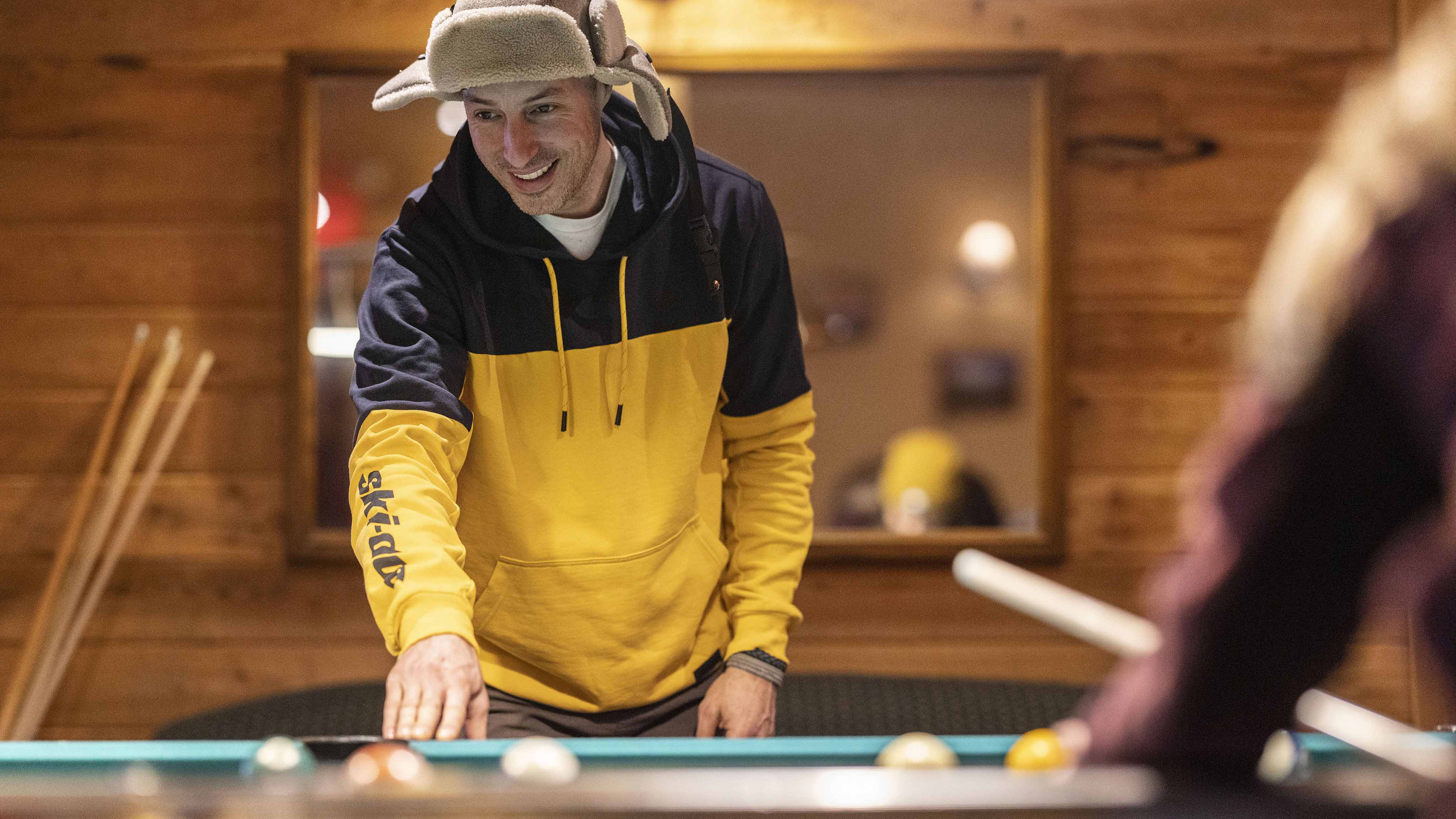 Man playing pool wearing the Ski-Doo Signature Collection