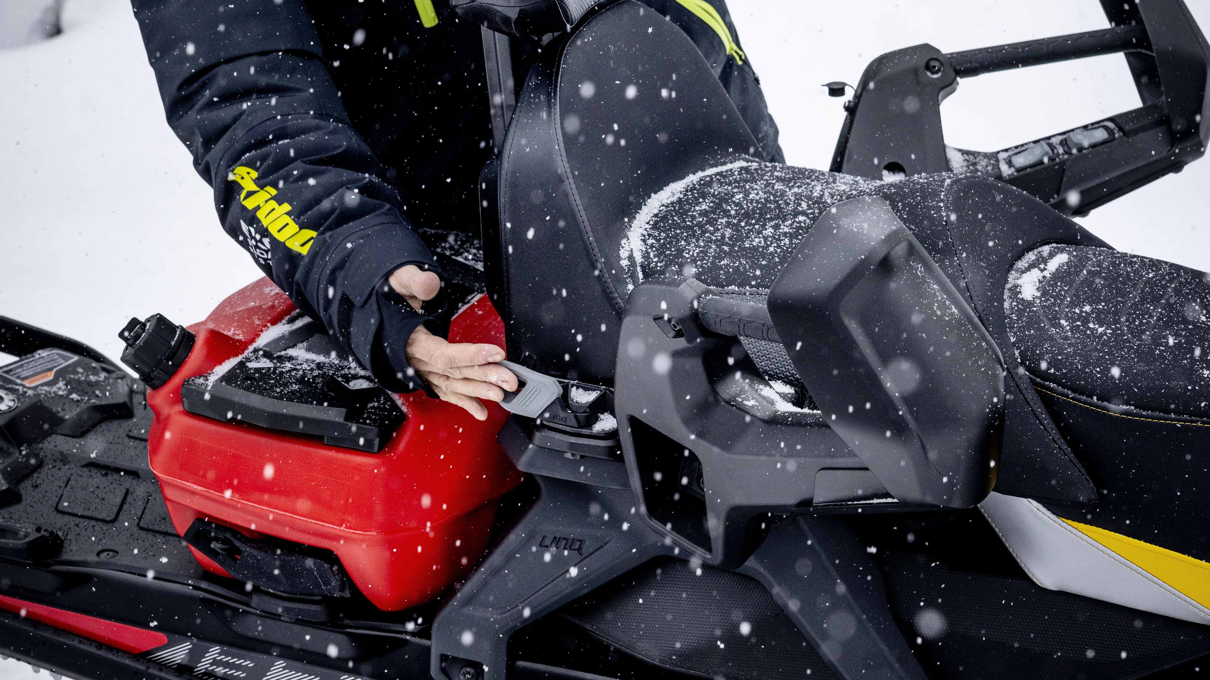 Man installing the LinQ 1+1 Seat on his Ski-Doo snowmobile