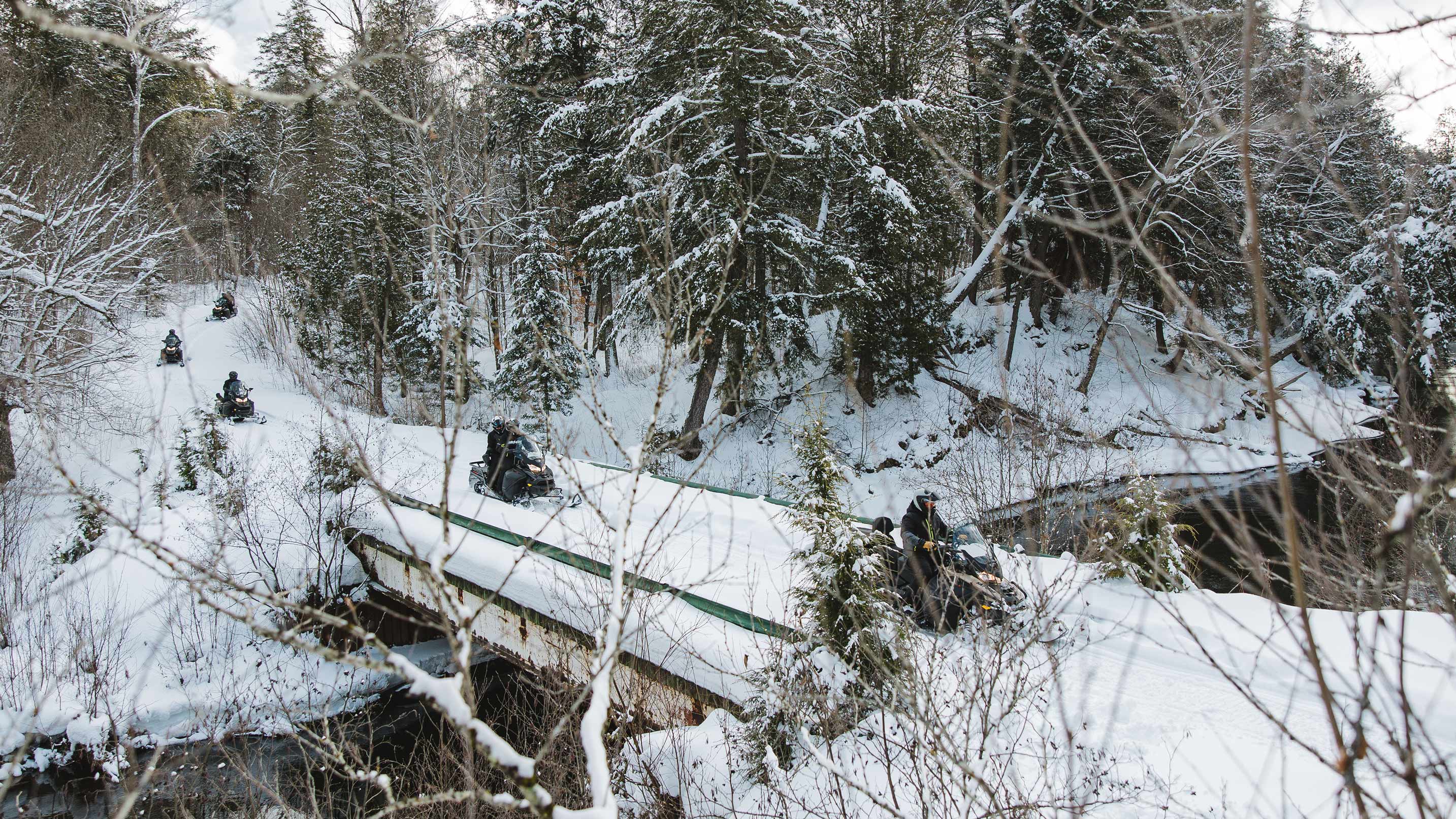 Snowmobilers on an Uncharted Society guided adventure