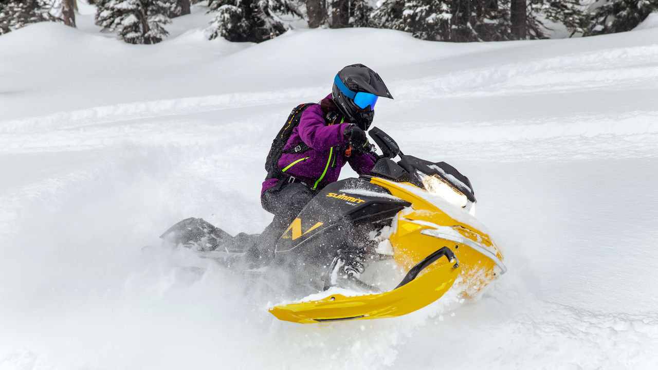 Woman enjoying deep snow riding with the Ski-Doo Summit Neo+