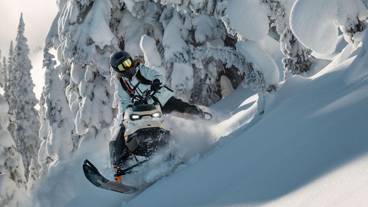 Woman riding a Ski-Doo Summit in a technical sidehill