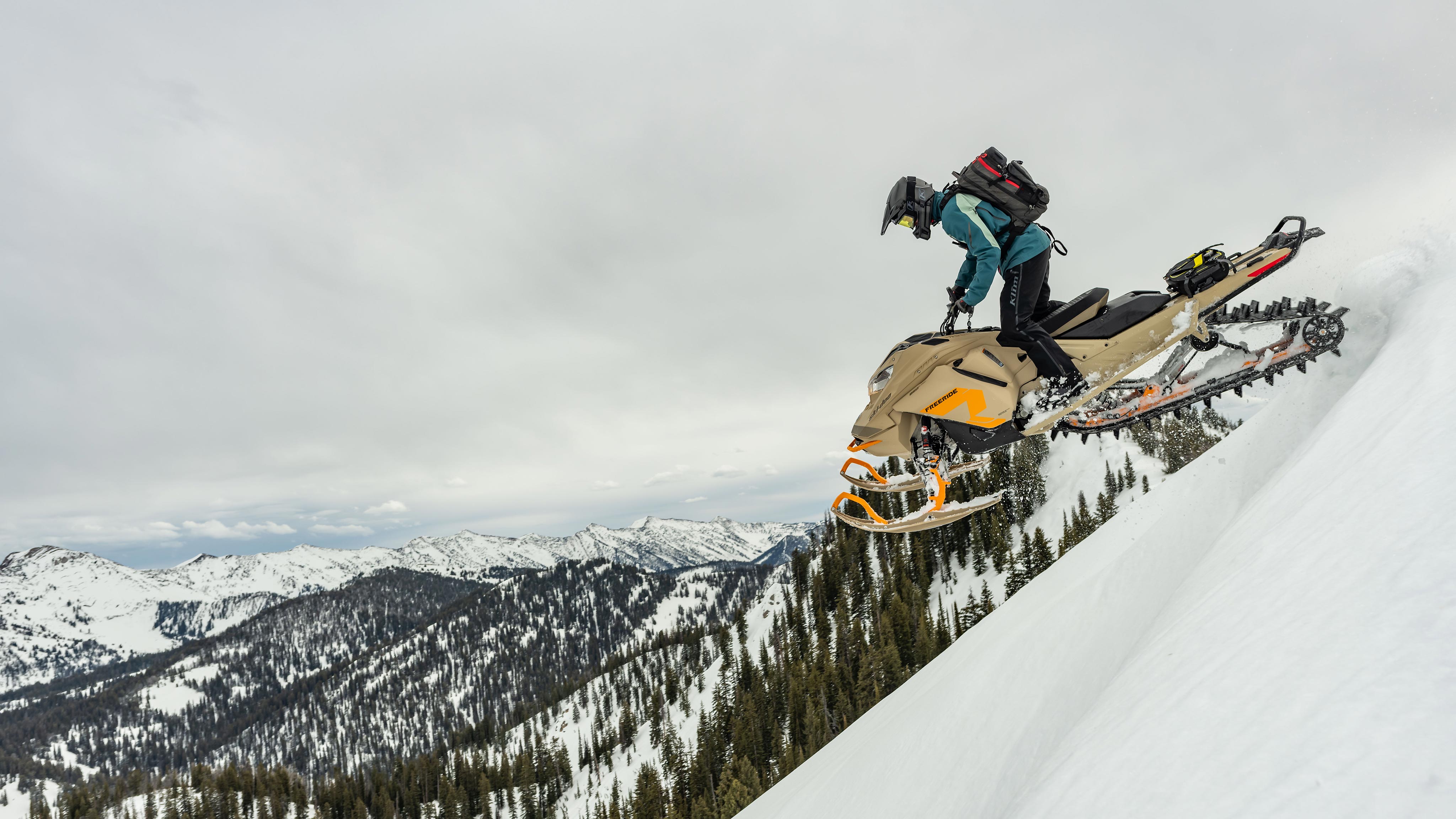 Ski-Doo Ambassador Mason Rutledge riding a snowmobile in mountain