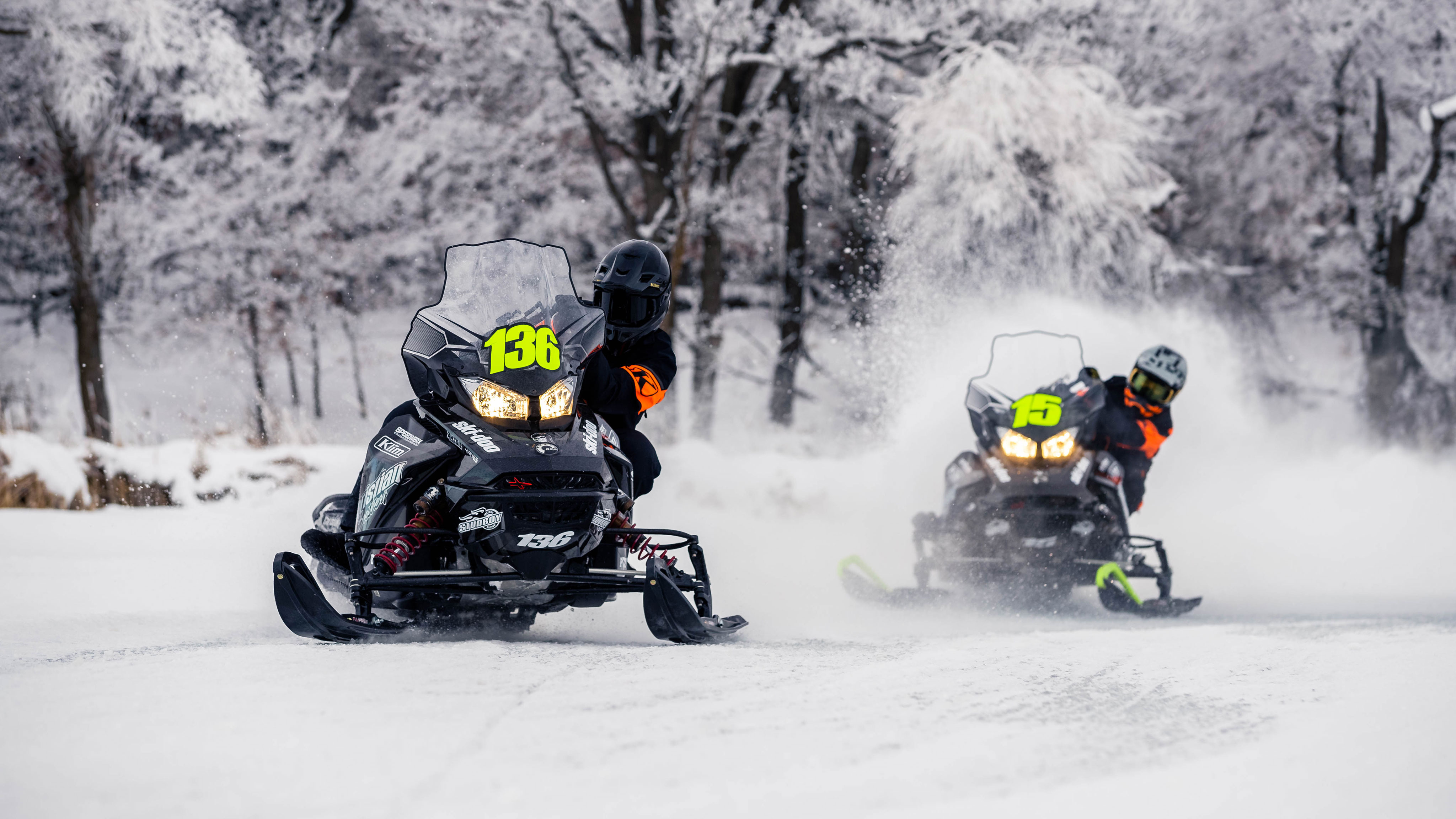 Two Ski-Doo riders on a snowmobile race