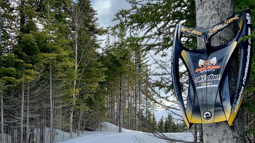 Snow PASS sign on a Ski-Doo trail