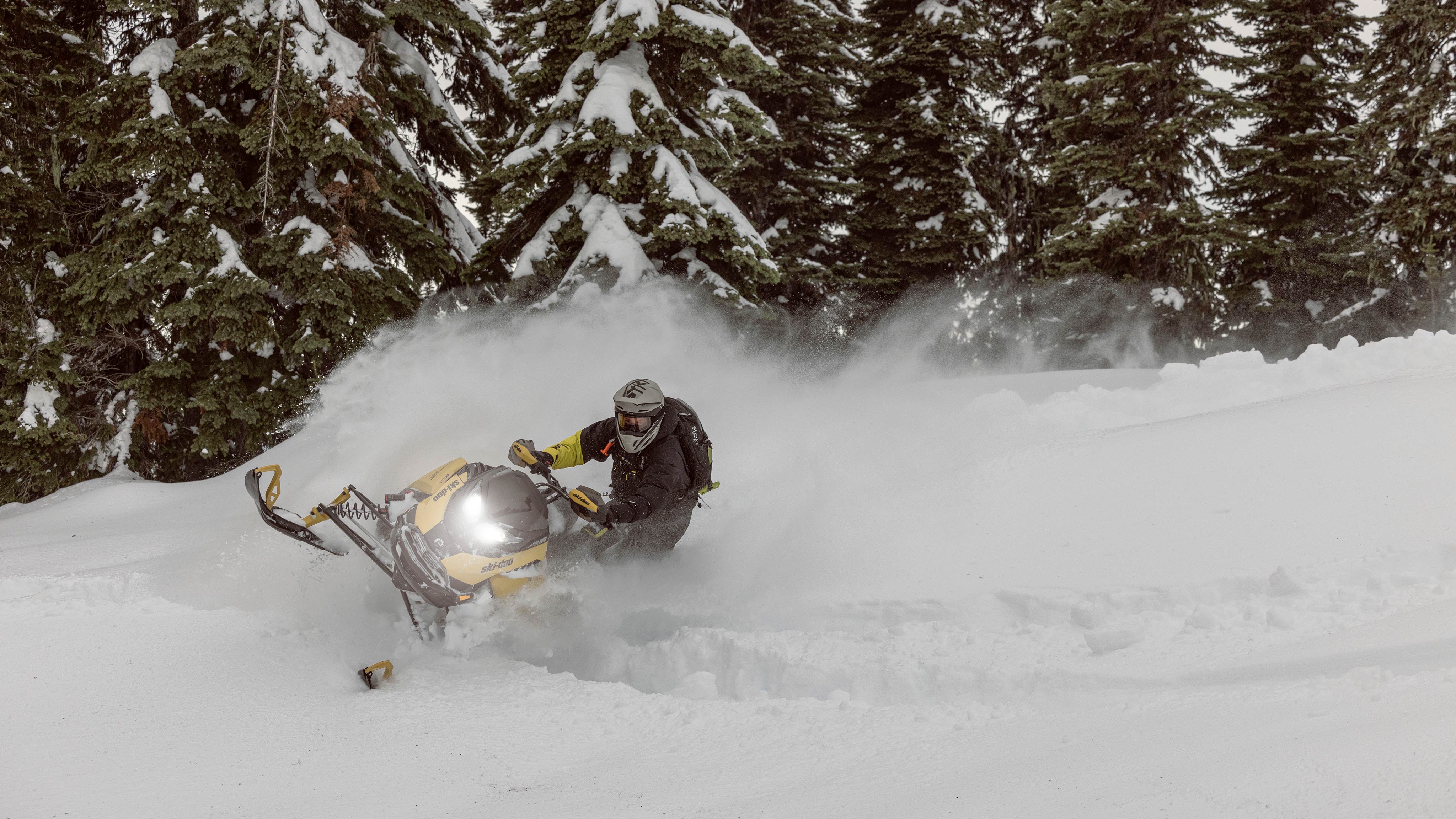 2025 Ski-Doo Backcountry Crossover snowmobile riding in deep snow