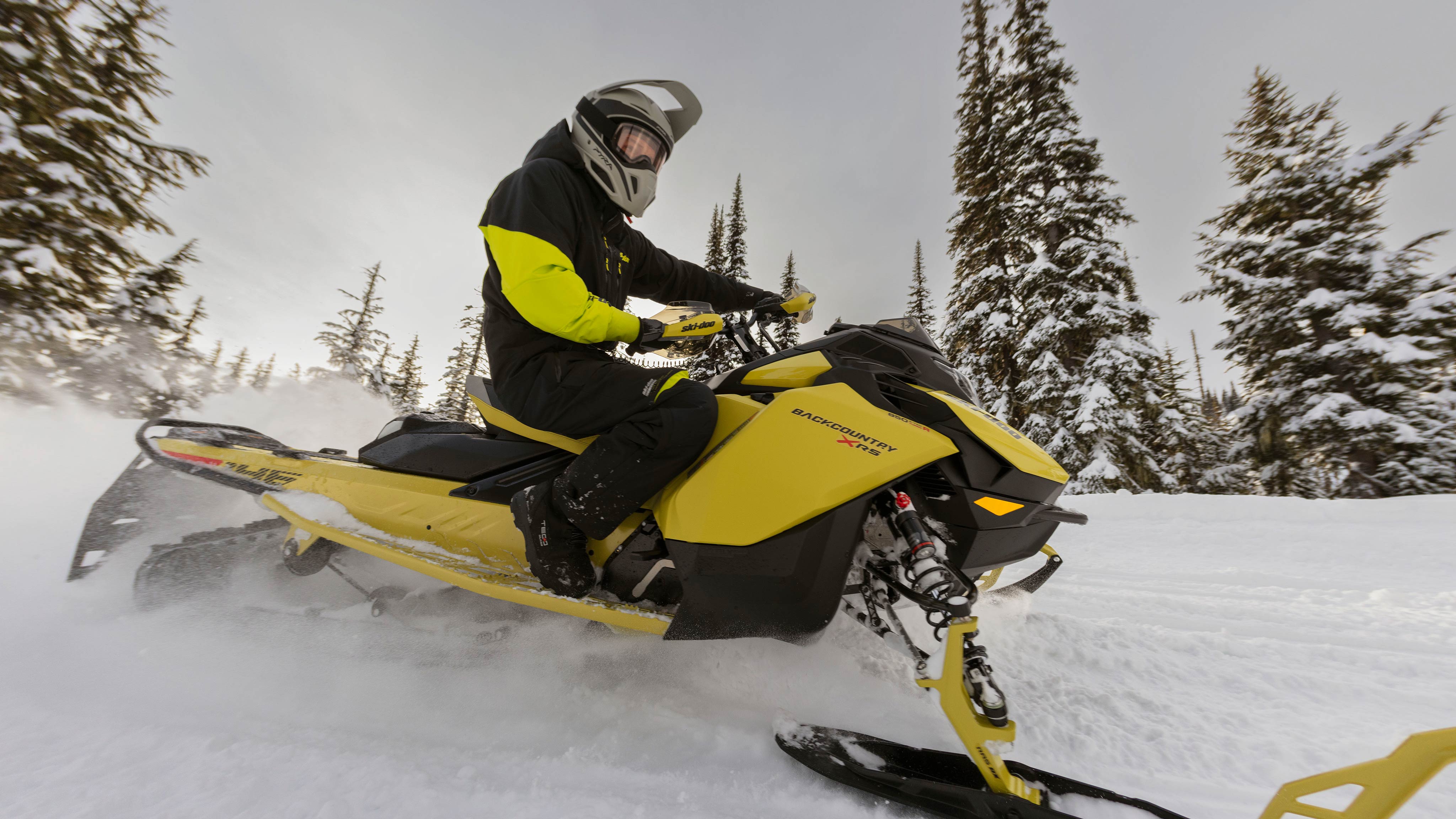 Rider riding a 2025 Ski-Doo Backcountry X RS crossover snowmobile