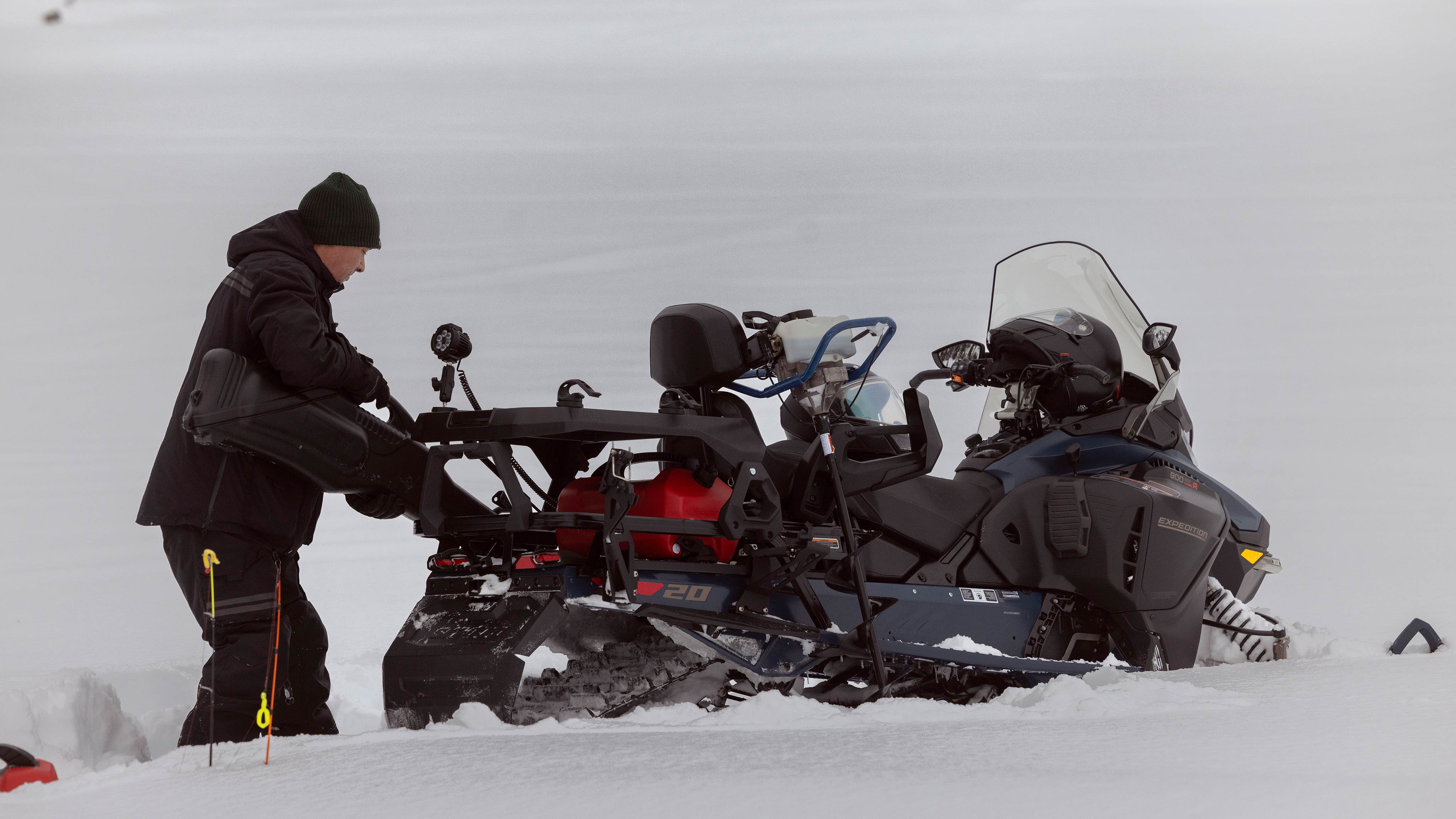 Rider storing items on his 2025 Ski-Doo Expedition snowmobile
