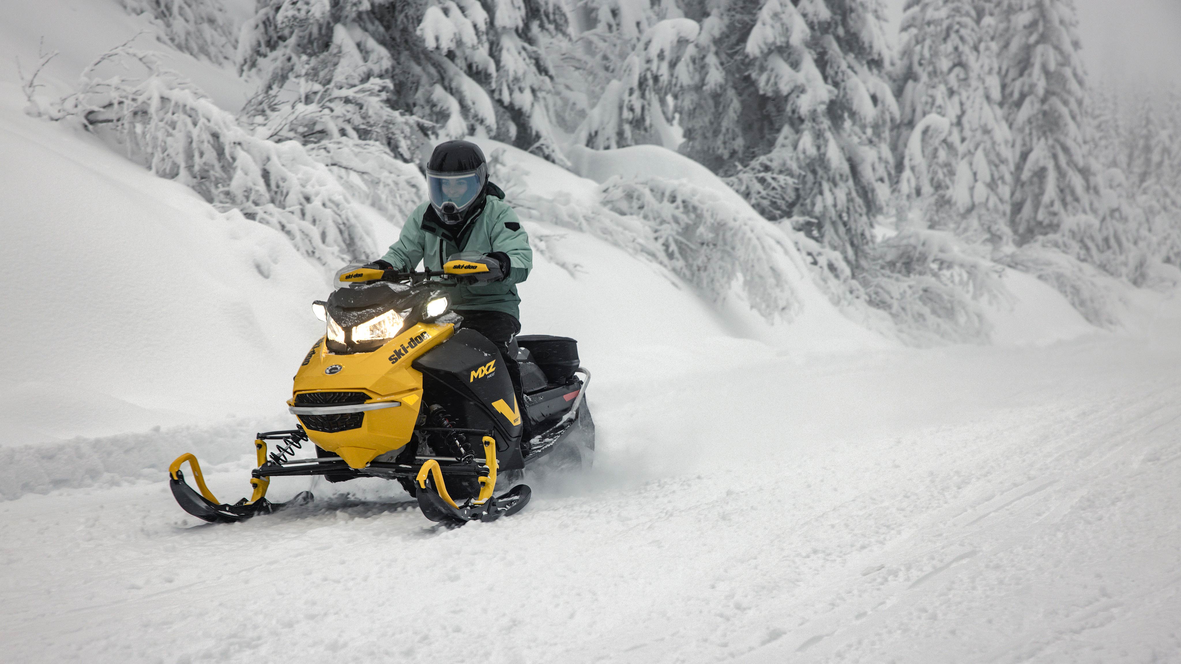 Woman on a 2025 Ski-Doo MXZ Neo+ snowmobile