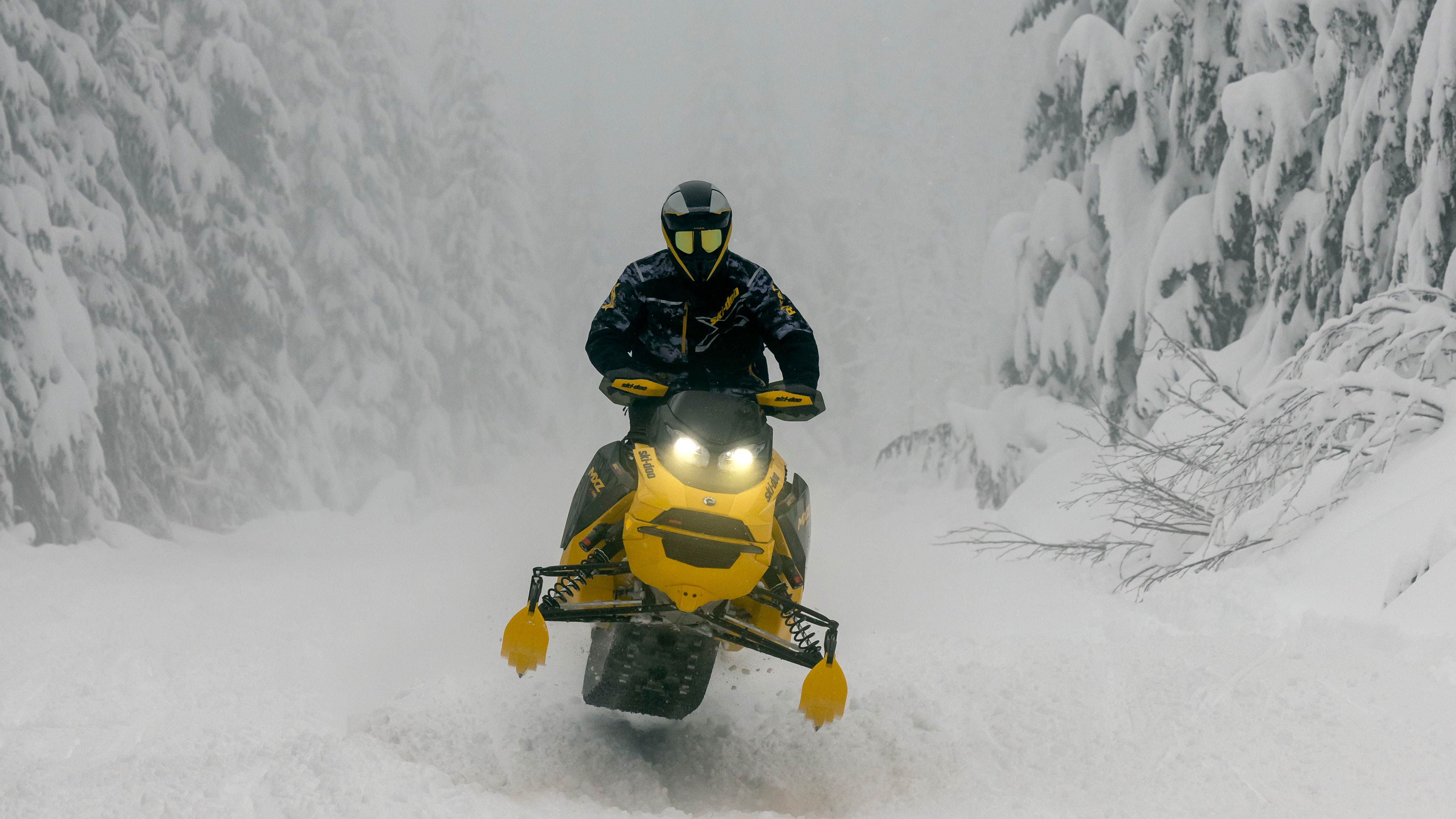 2025 Ski-Doo MXZ riding through a snowstorm