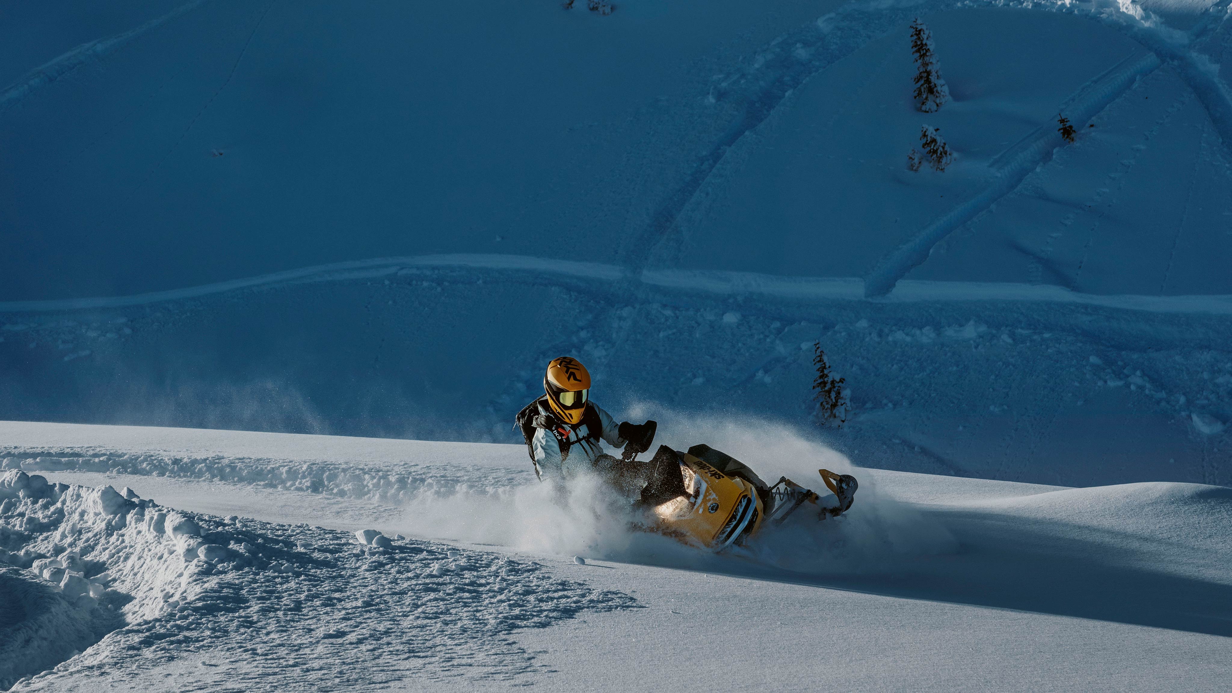 Rider doing down a snowy mountain on a 2025 Ski-Doo NEO+ snowmobile