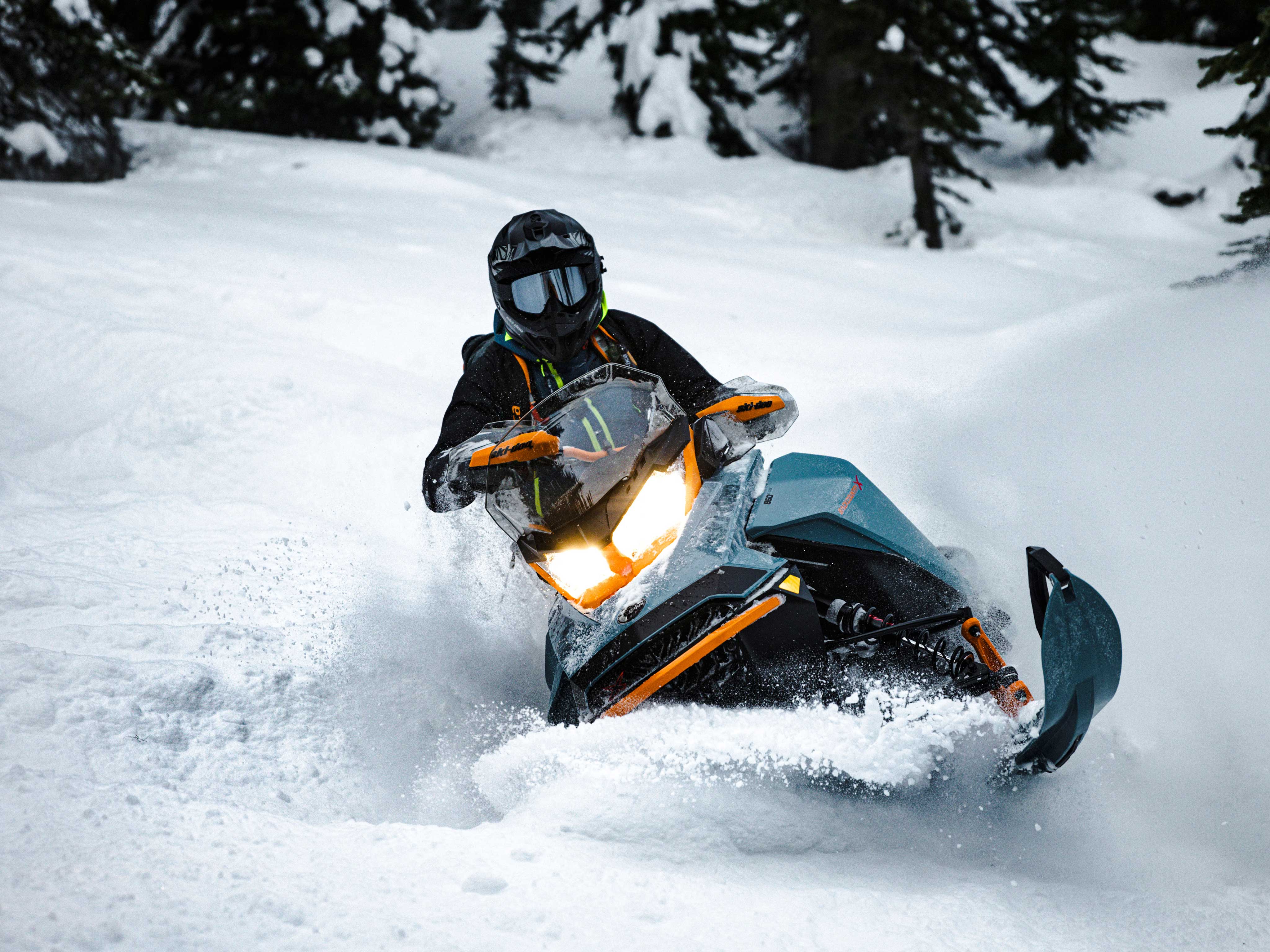 Man in deep snow with his 2022 Ski-Doo Backcountry