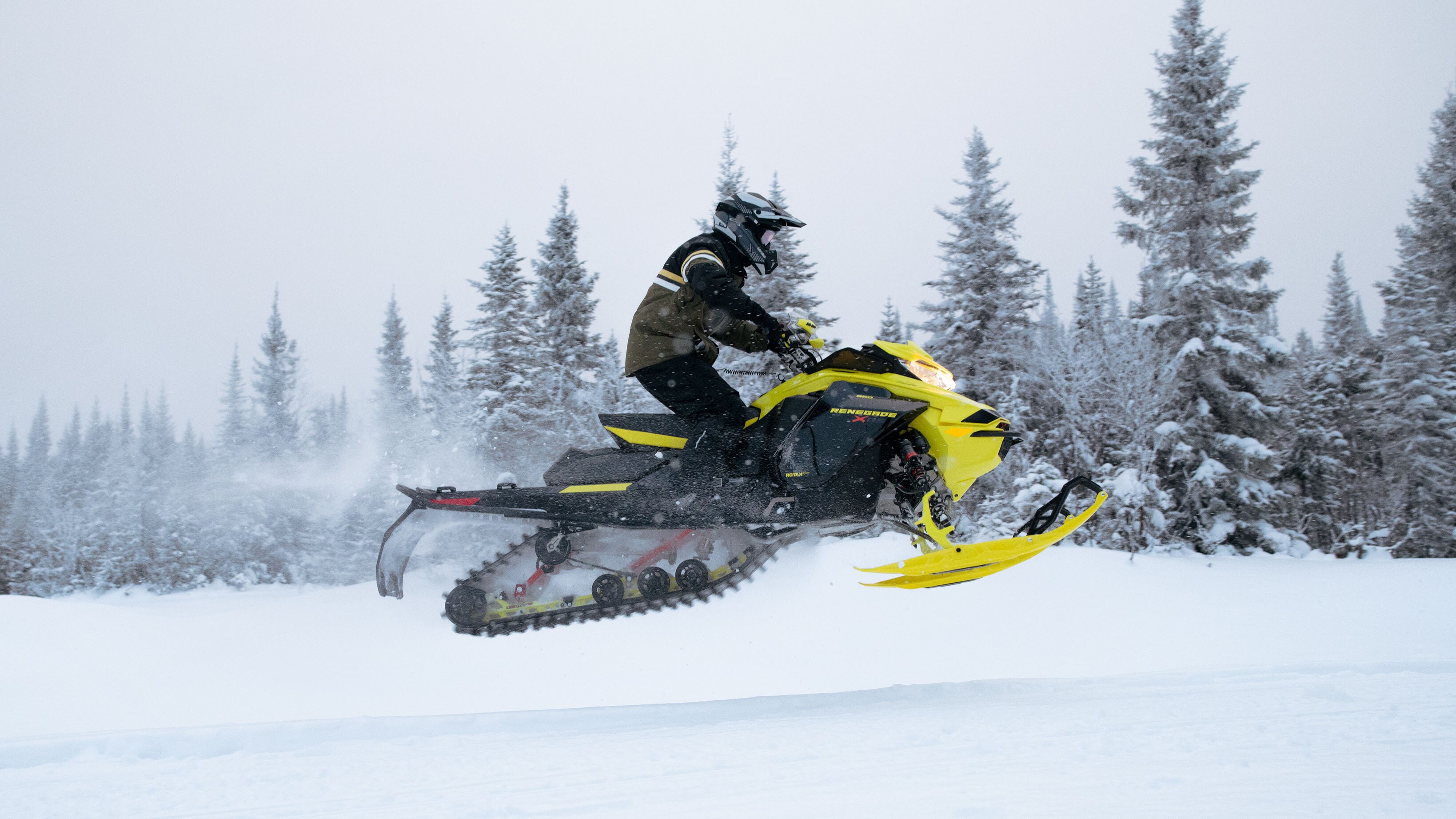 Man jumping with his Ski-Doo Renegade on a trail