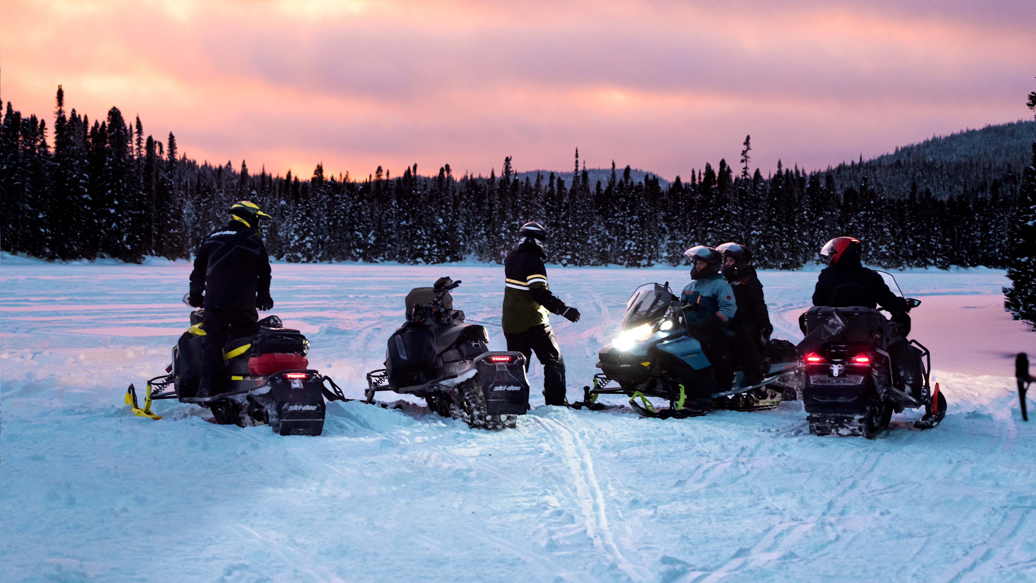 5 Ski-Doo riders stopped in a clearing