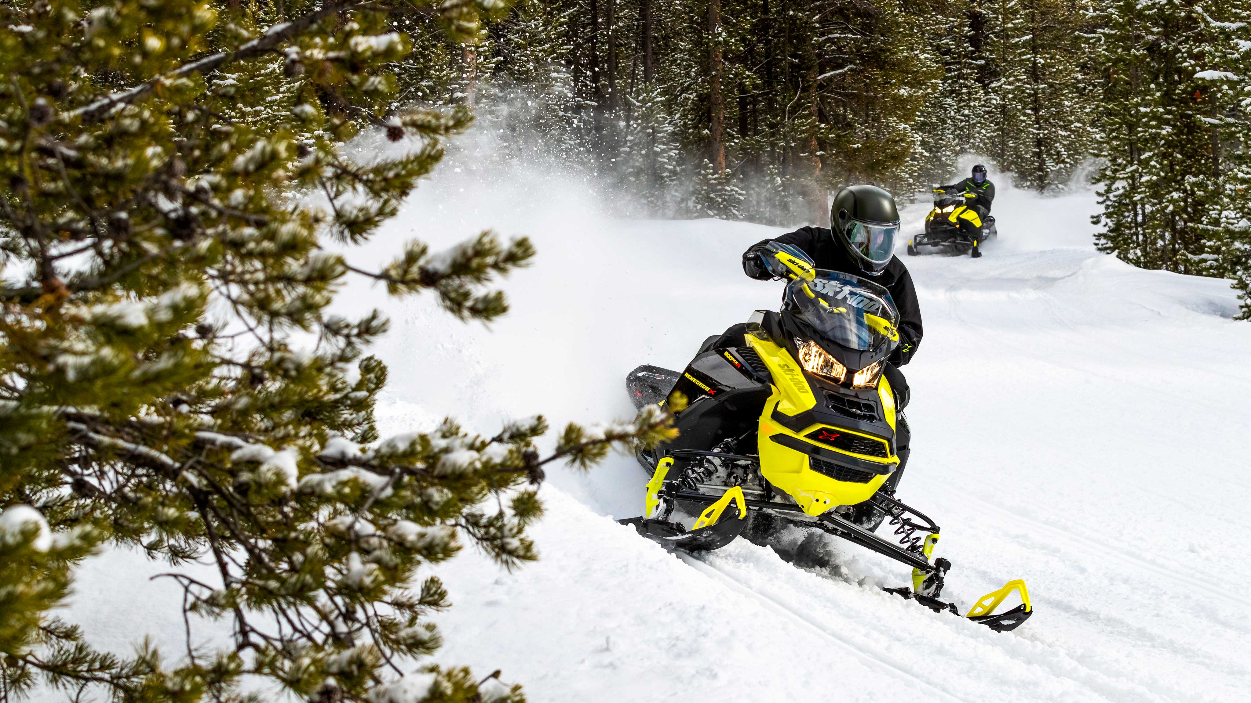 Man riding the new Ski-Doo on a turn in a trail