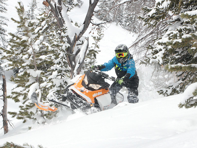 Bret Rasmussen and his Summit Ski-Doo snowmobile in deep snow