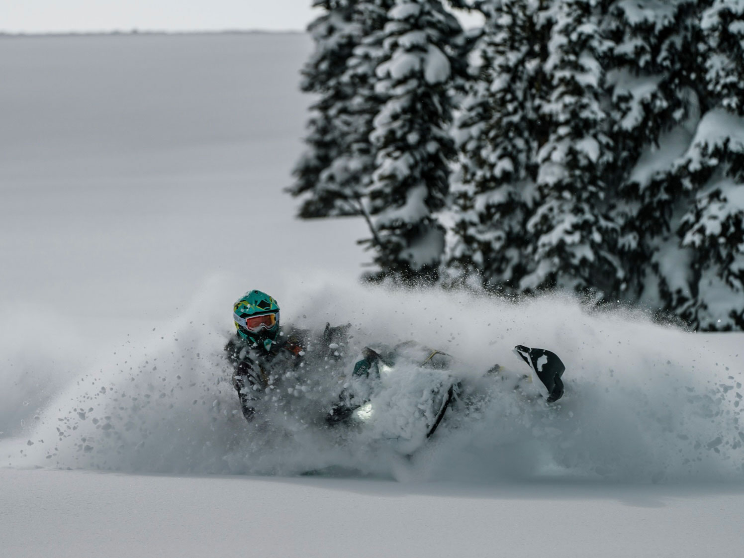 Ski-Doo Ambassador Michelle Salt riding a snowmobile in deep snow