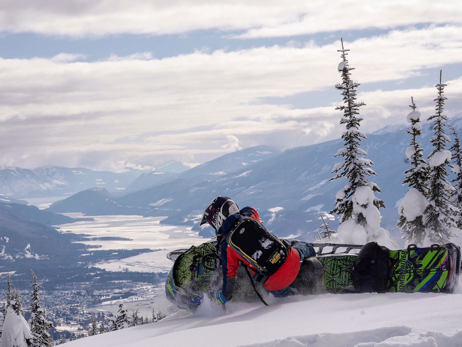 Ski-Doo Ambassador Michelle Salt riding a snowmobile on top of a montain