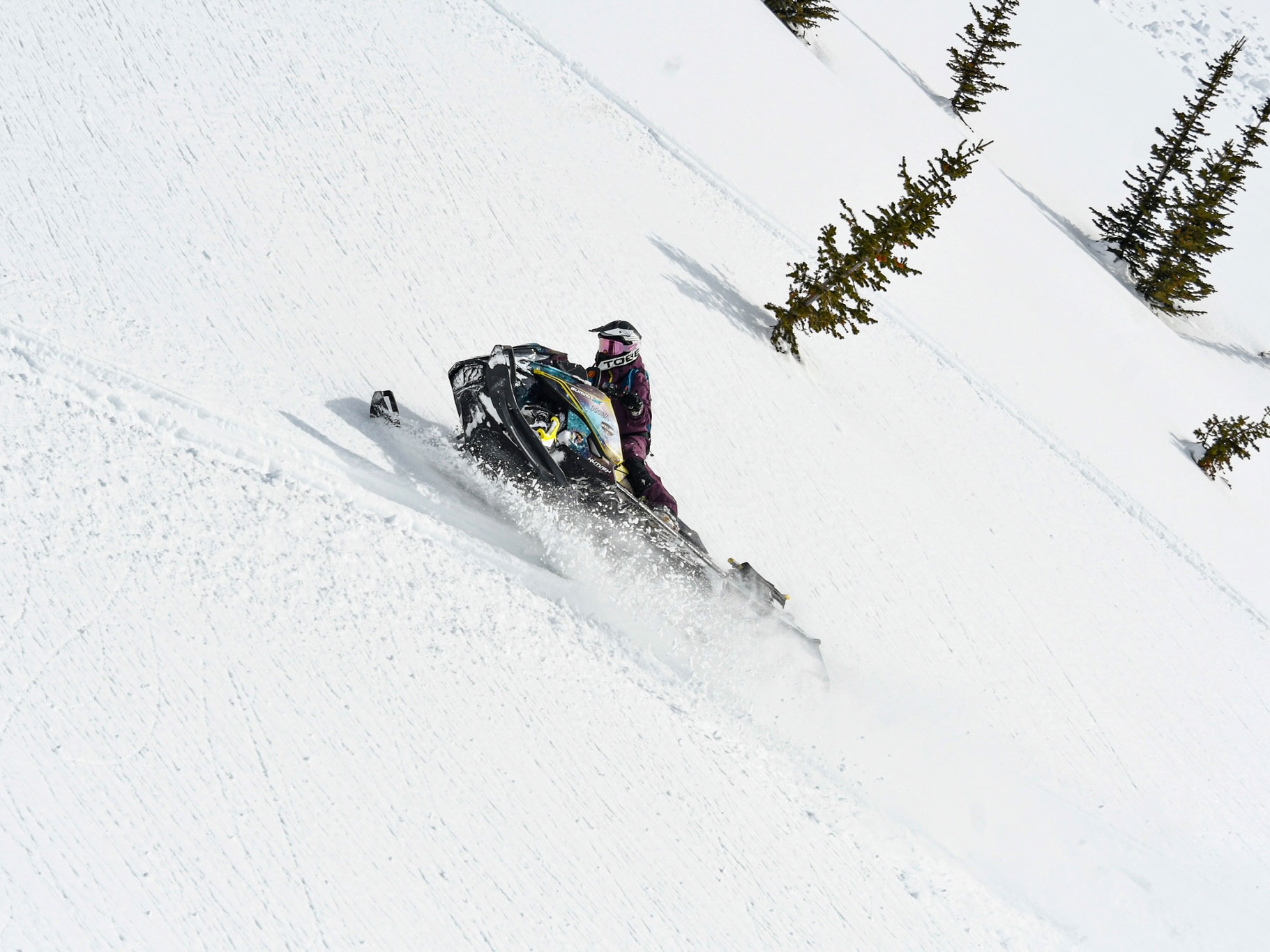 Ski-Doo Ambassador Michelle Salt riding a snowmobile on a hill