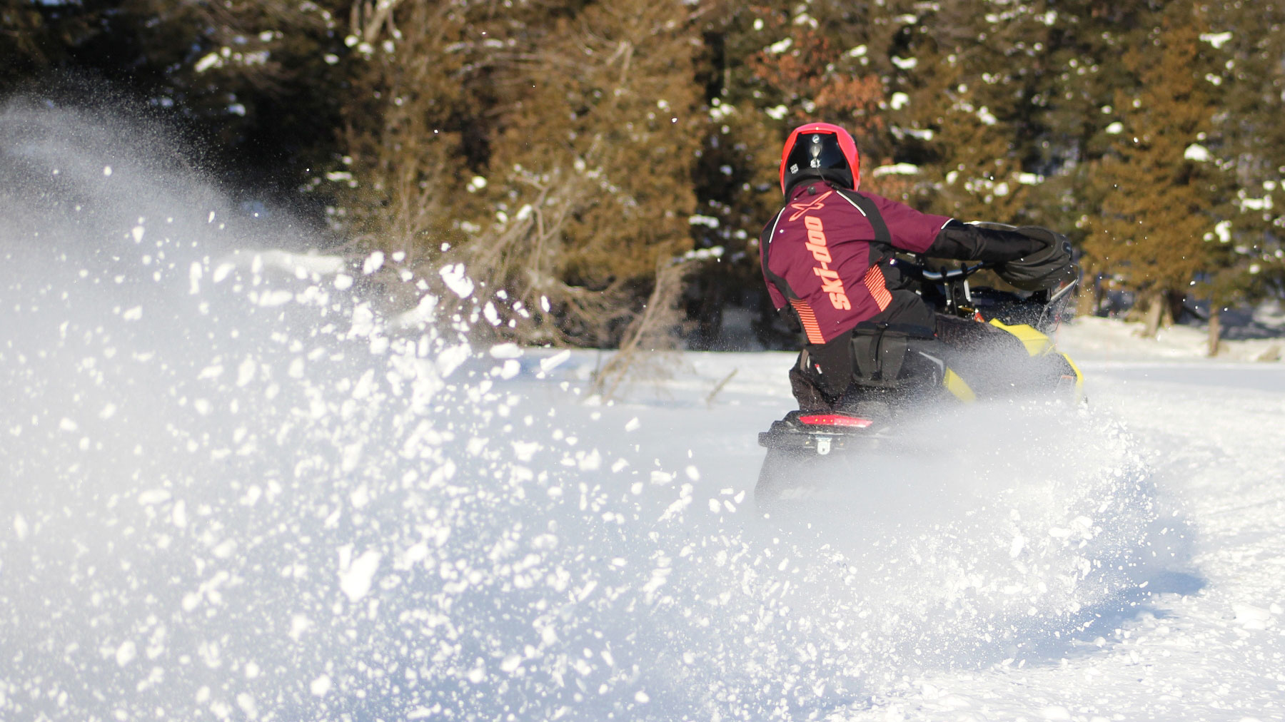 Ski-Doo Ambassador MJ Thompson riding a snowmobile