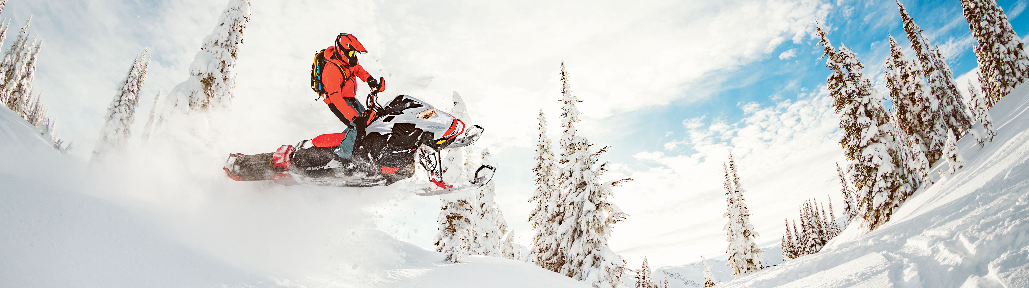 Man jumping with a Ski-Doo snowmobile in Deep-Snow