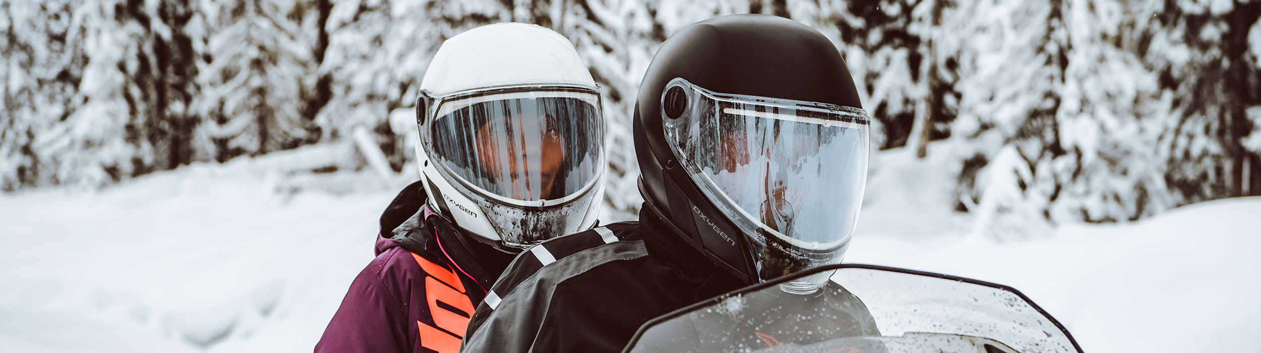 Couple wearing Oxygen Snowmobile helmets