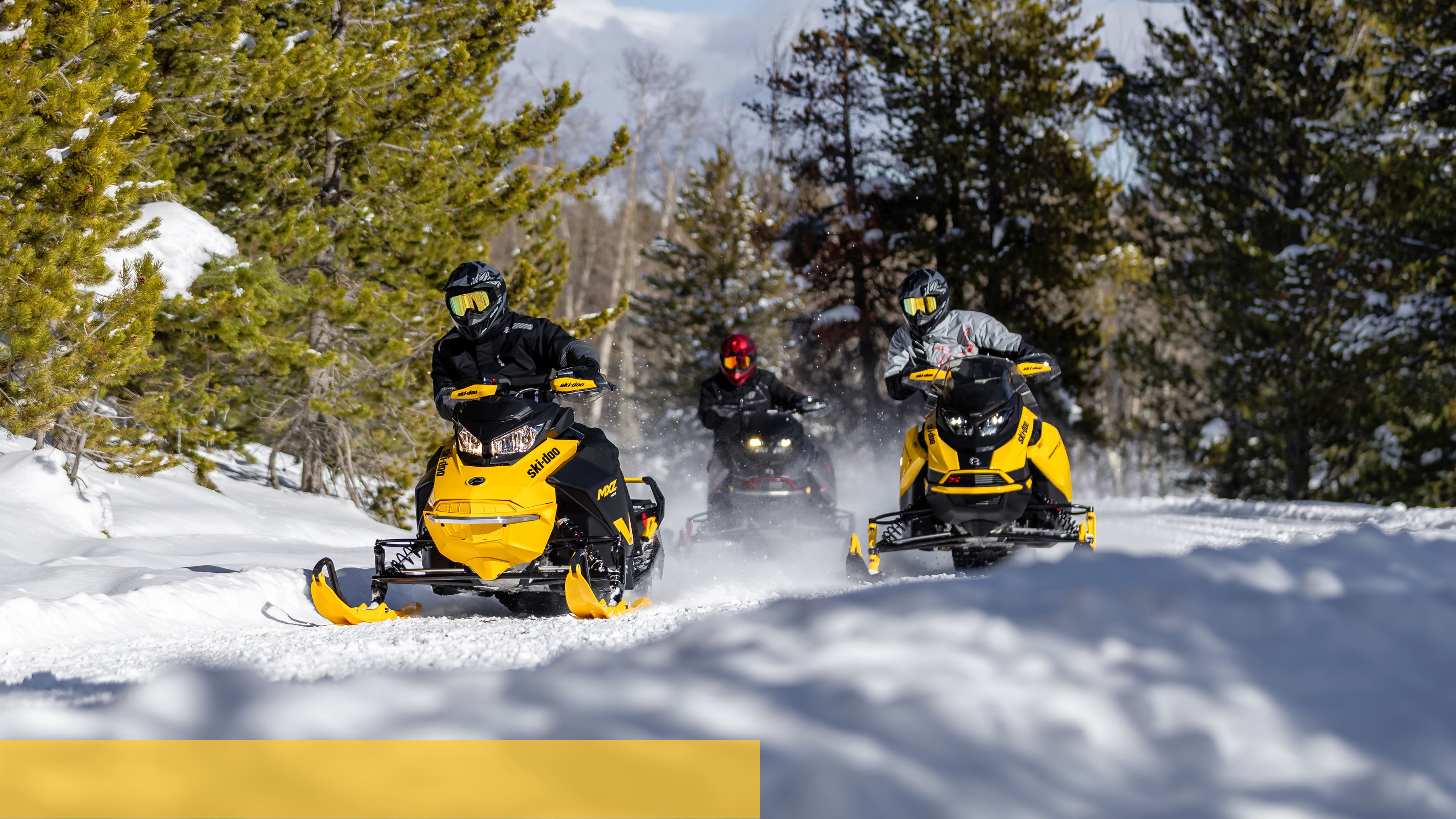 Family enjoying a snowmobile ride with the new Ski-Doo Lineup
