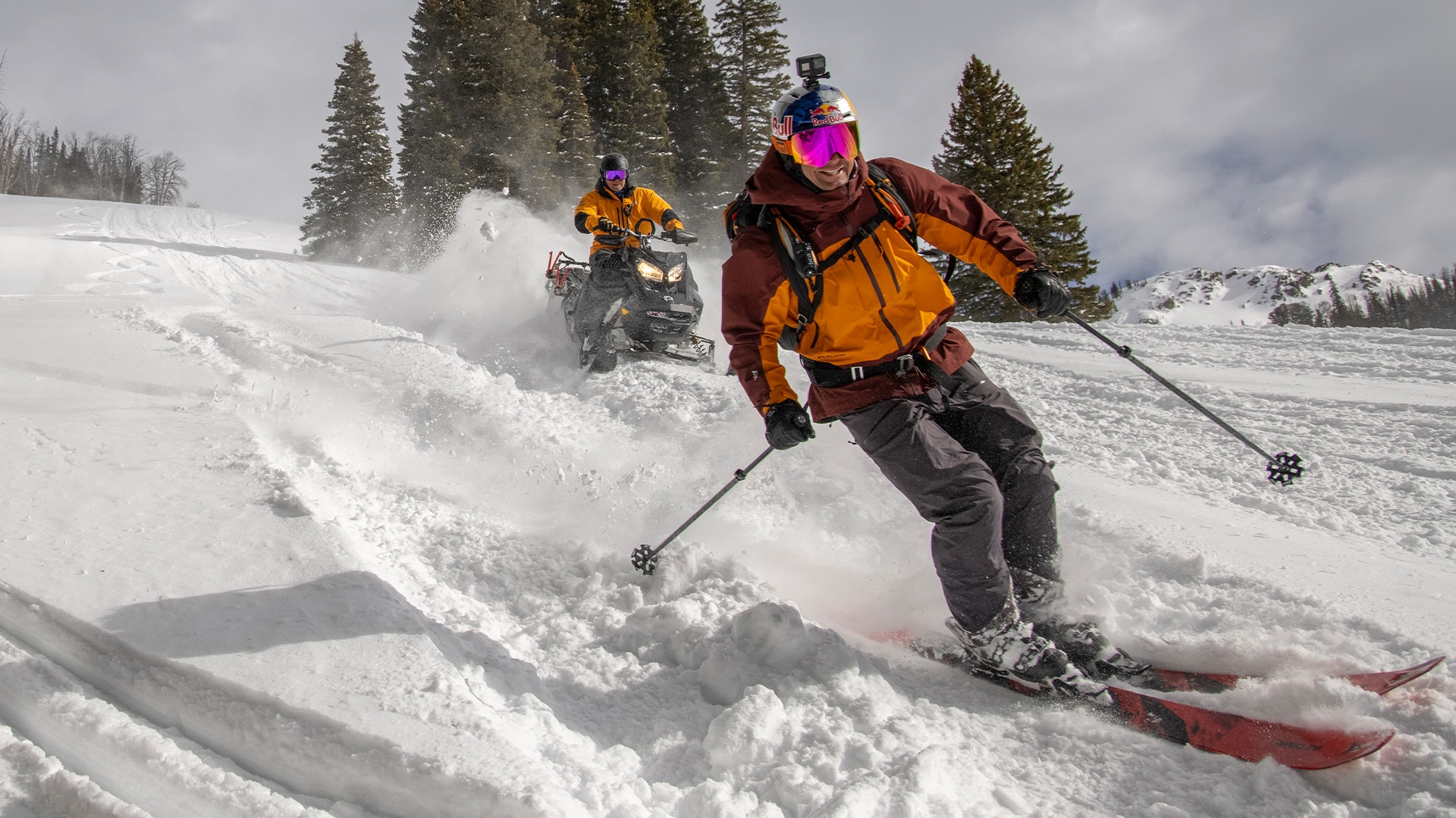 Ski-Doo riders and a skier on a mountain