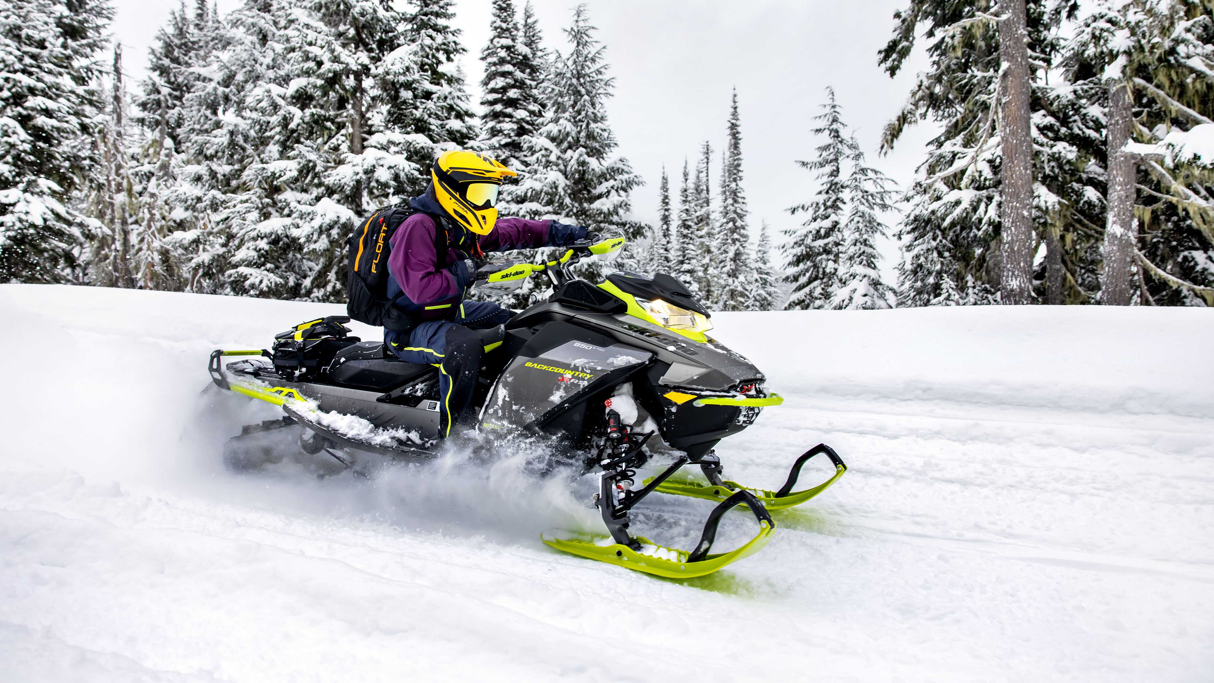 Woman snowmobiling on a trail with her 2023 Ski-Doo Backcountry