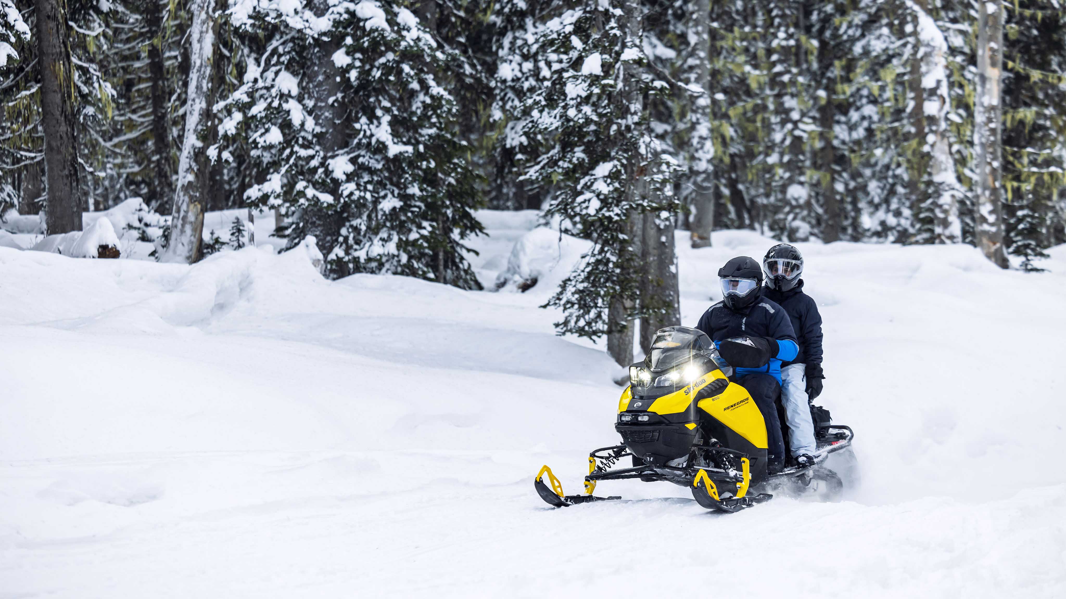 Couple riding the new SKi-Doo Trail snowmobile
