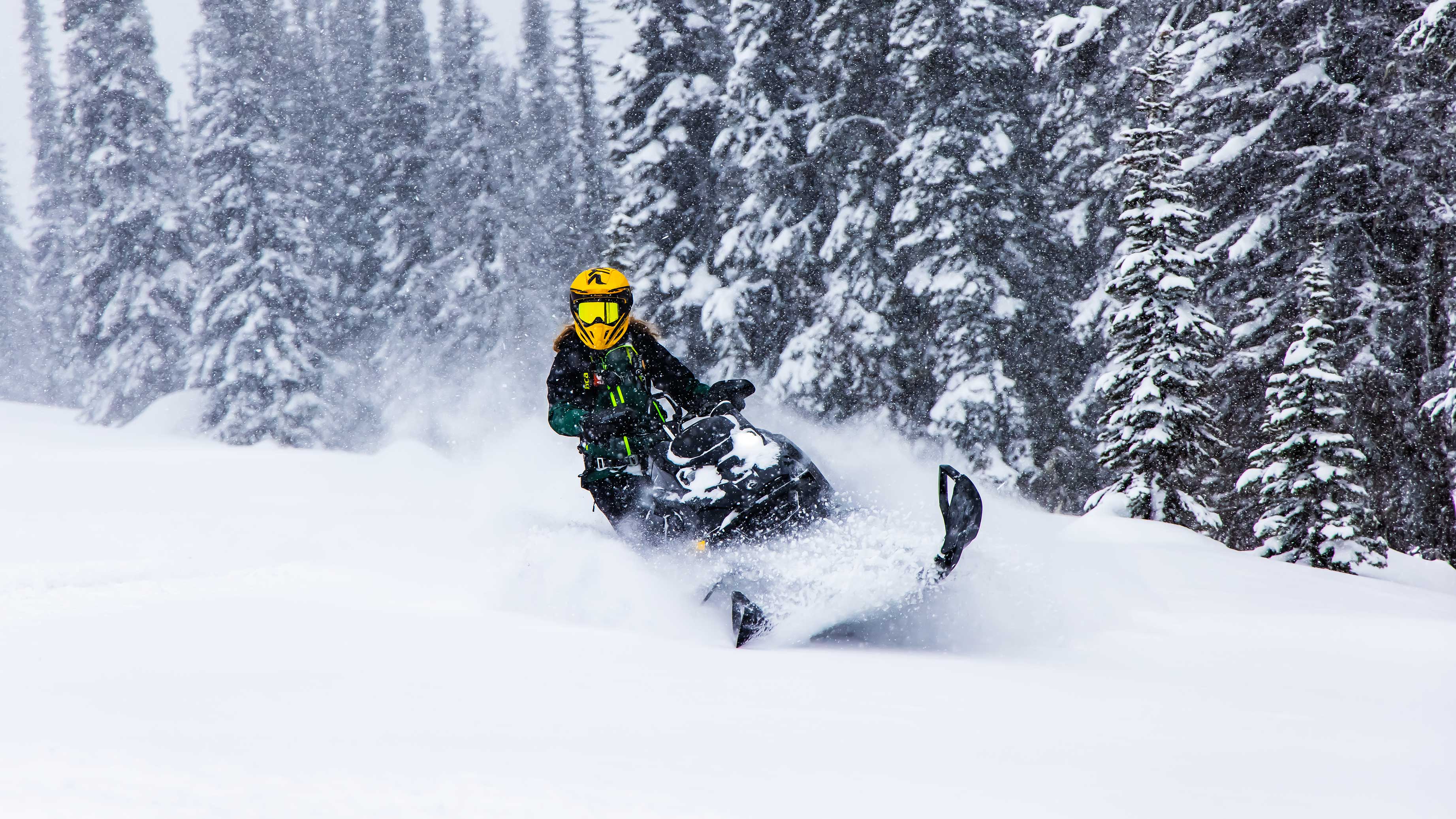 Stefanie Dean riding a Ski-Doo Summit Edge in Deep snow