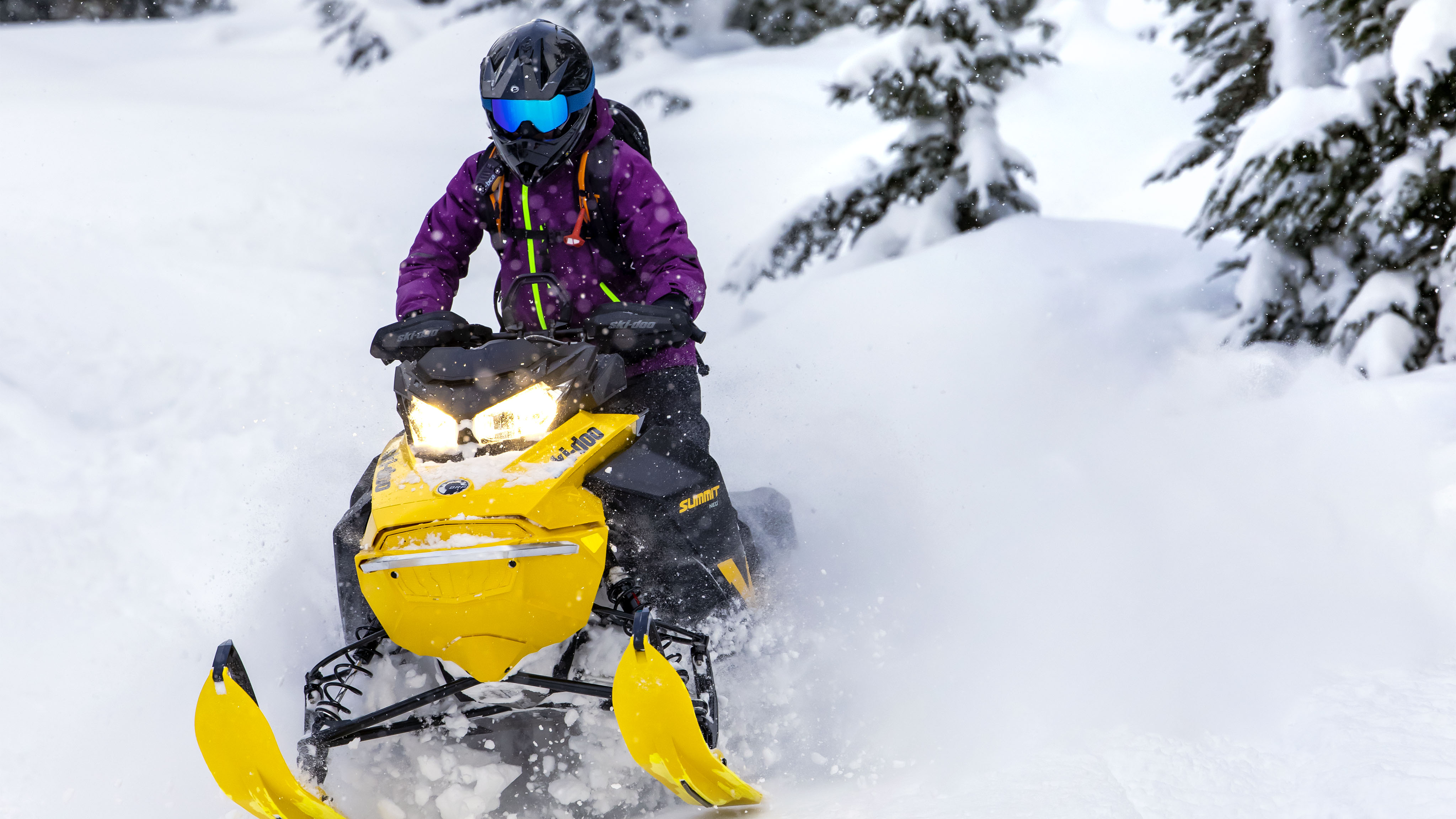 Woman riding the Summit Neo+ in deep snow