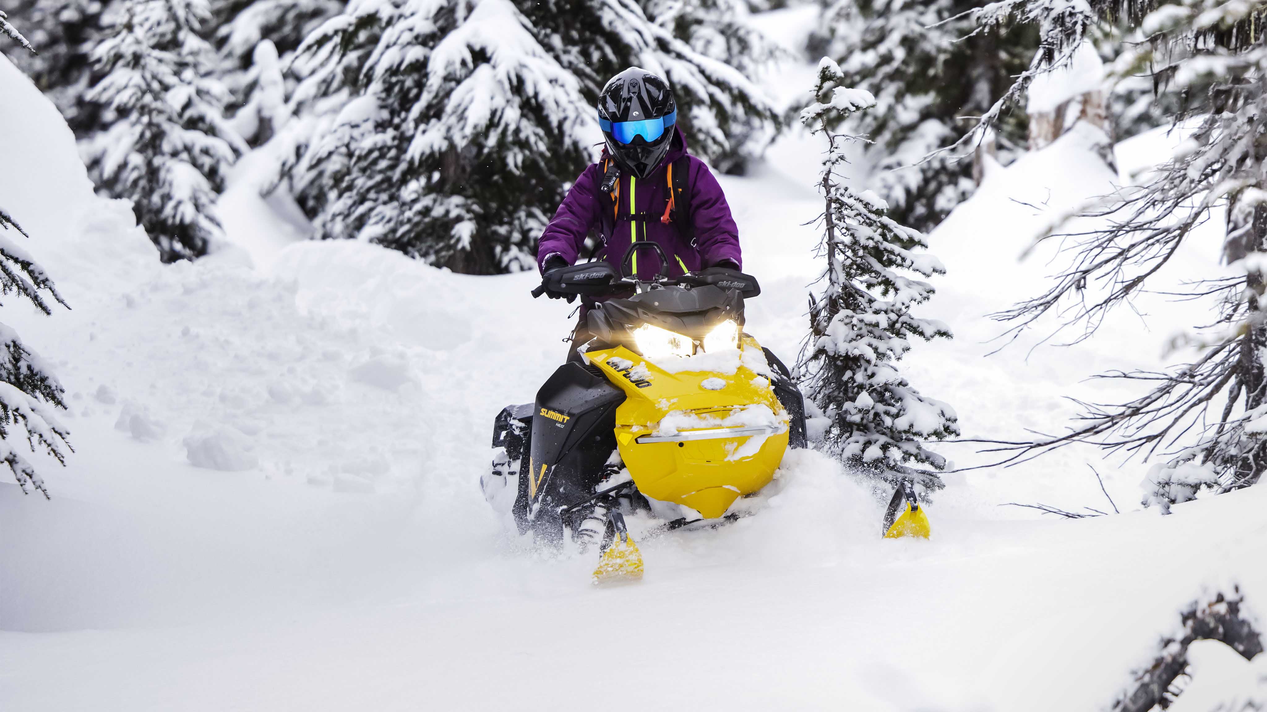 Femme profitant de la neige profonde avec son Ski-Doo Summit