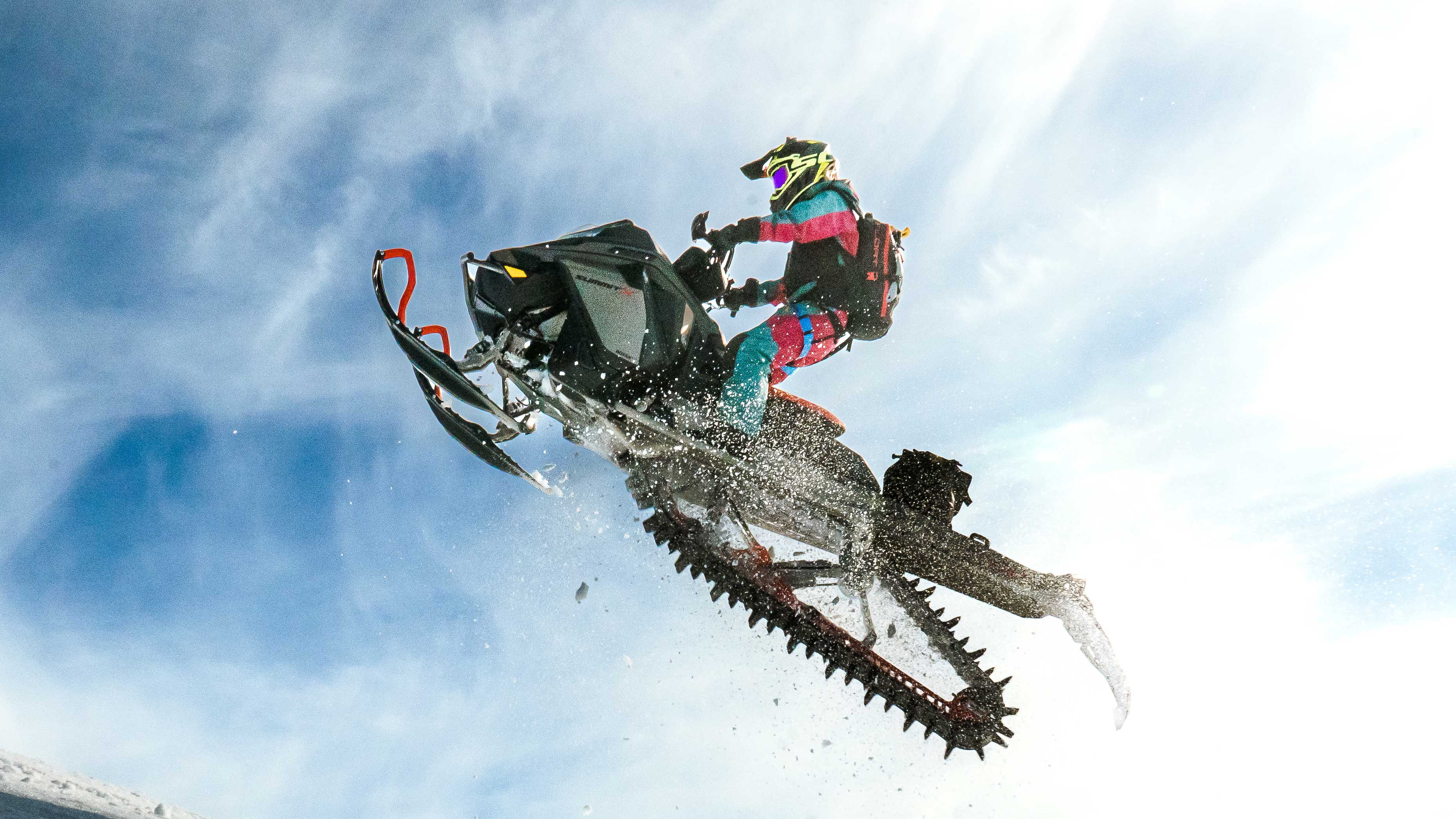 Lisa Granden making a jump with her Ski-Doo snowmobile