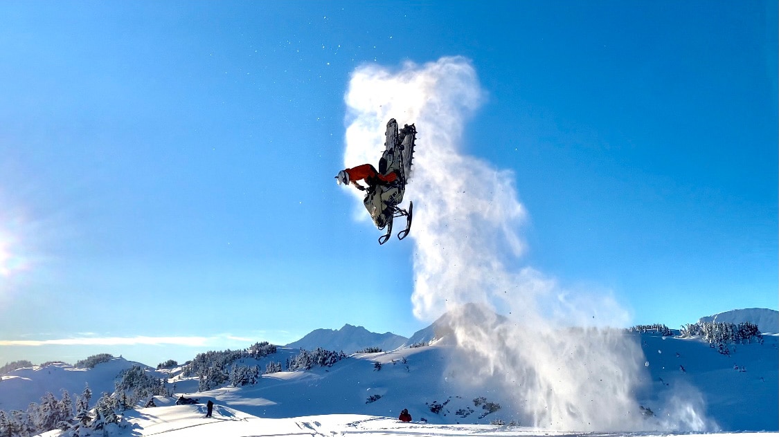 Ski-Doo Ambassador in the air with a Ski-Doo snowmobile