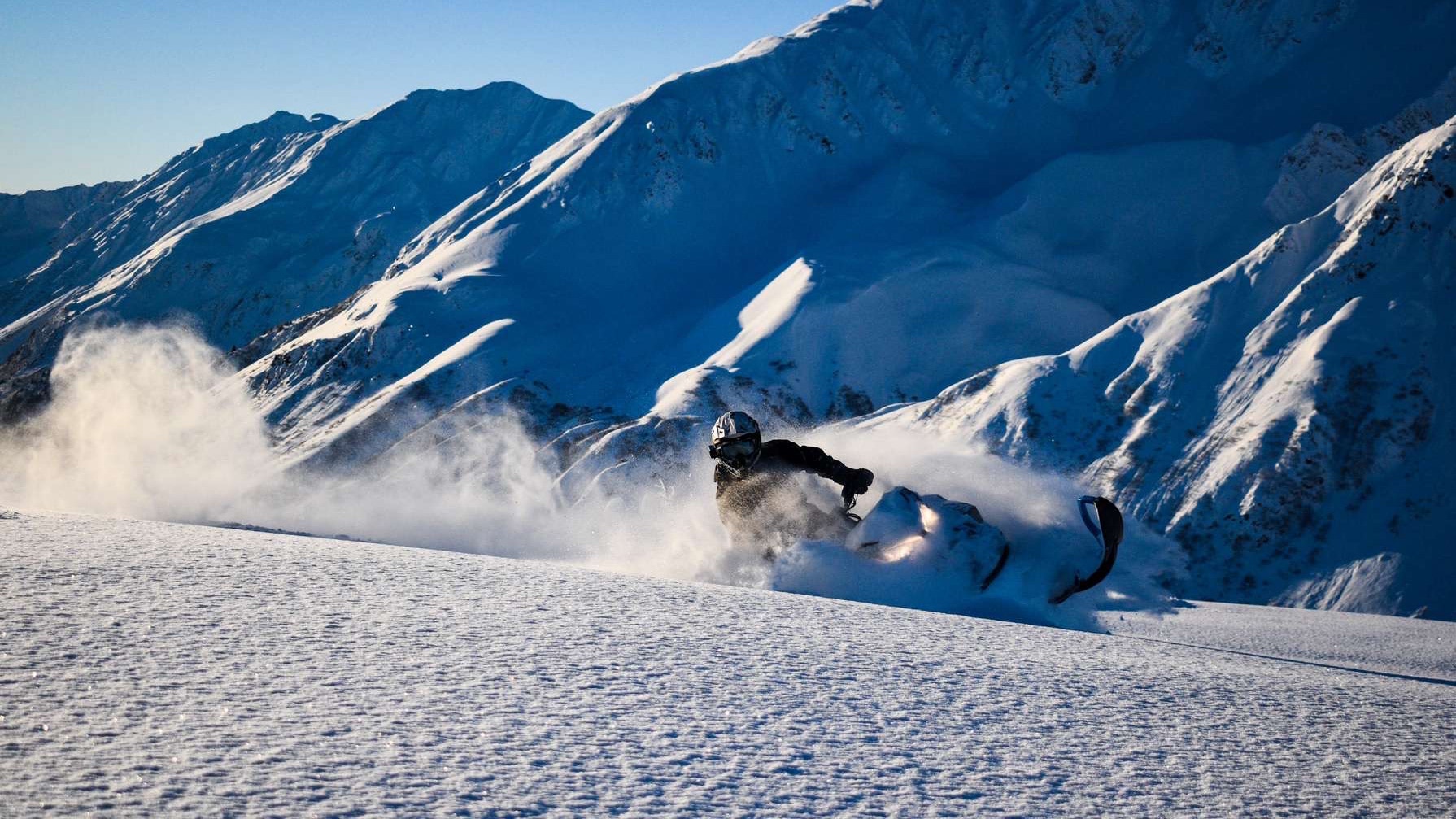 Nik Pahno riding a Ski-Doo snowmobile in deep snow